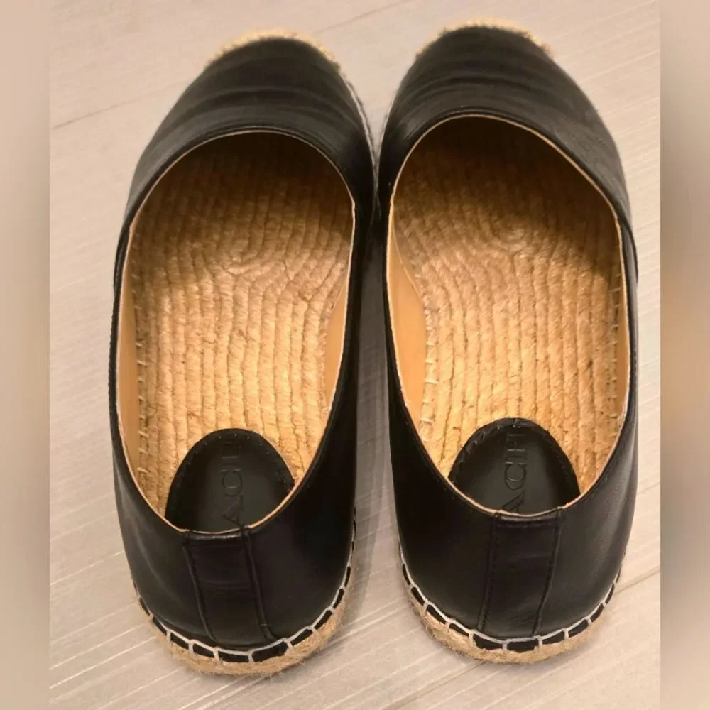 Coach Carley Black leather Espadrille Slip-On Shoes with Coach design on top.